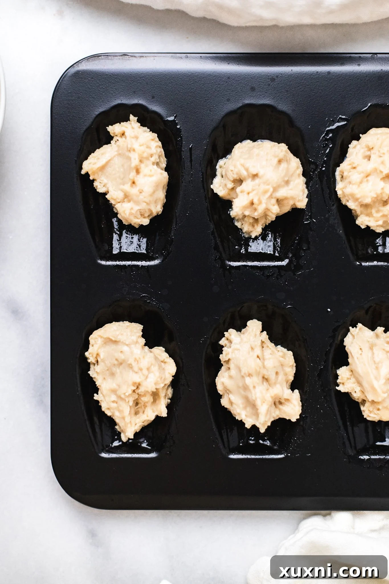 Madeleine batter in mold - perfectly spooned into cavities