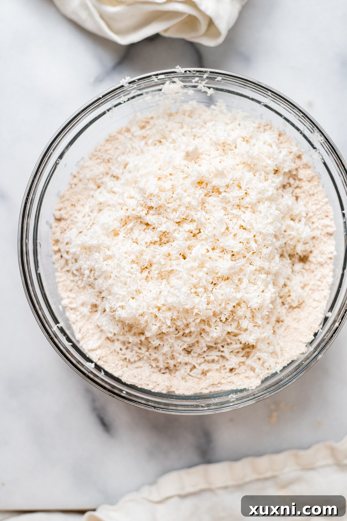 Grated cold vegan butter mixed into dry ingredients for scones.