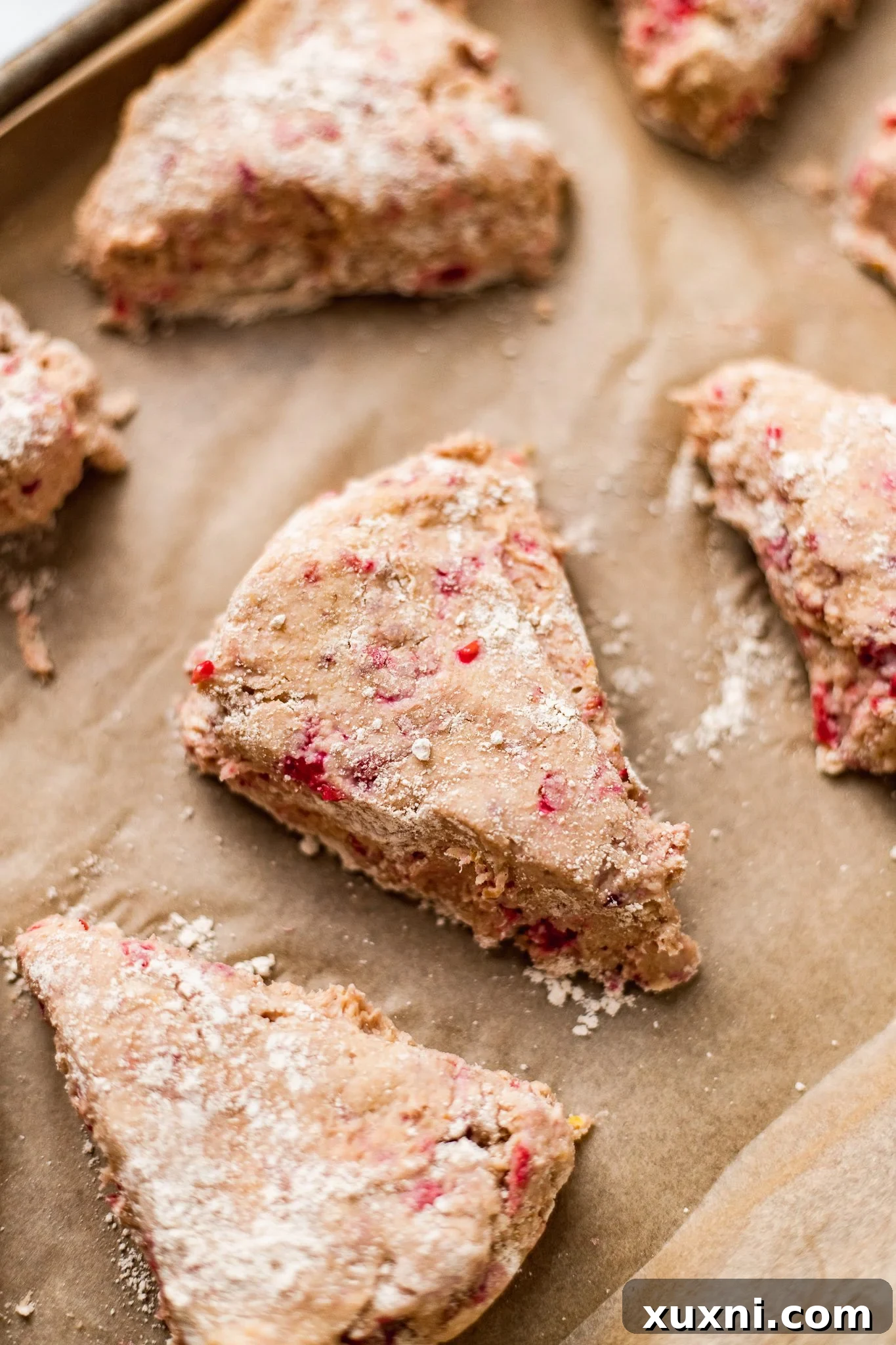 Shaping and slicing vegan scone dough into wedges.