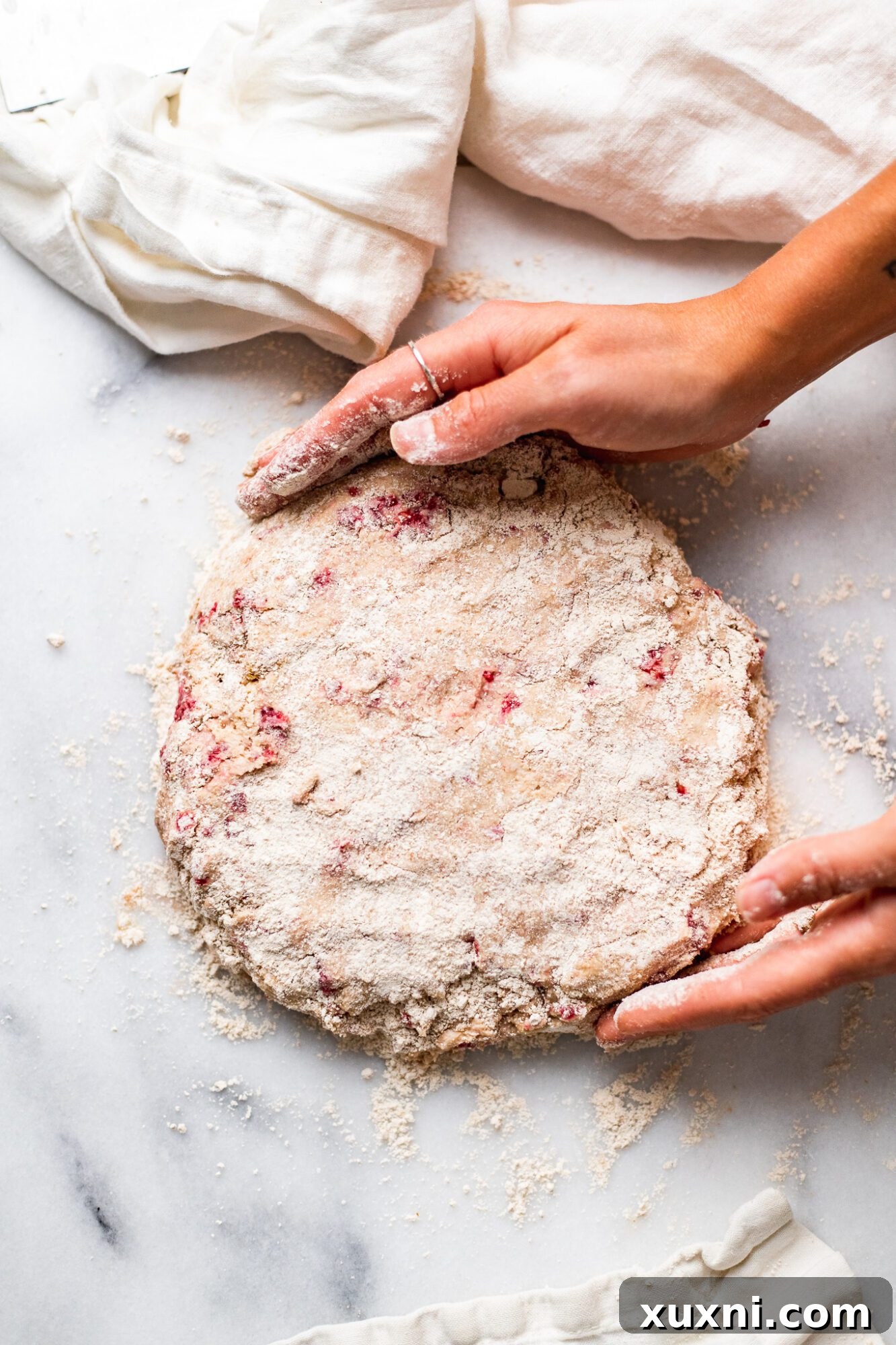 Step-by-step image showing how to laminate scone dough by folding it.