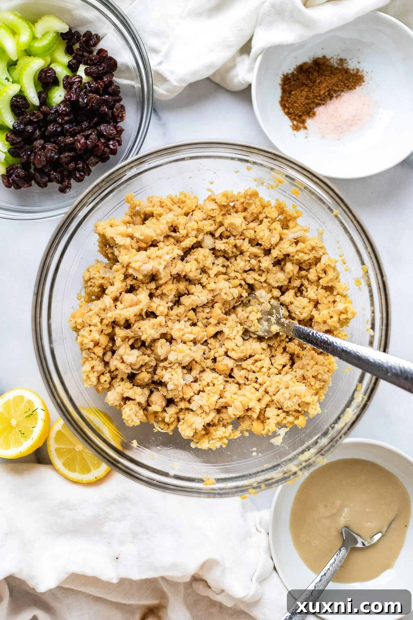 Plant Based Chickpea Tuna Salad 5 Mashed chickpeas in a white bowl, showing the perfect chunky texture for vegan tuna salad.