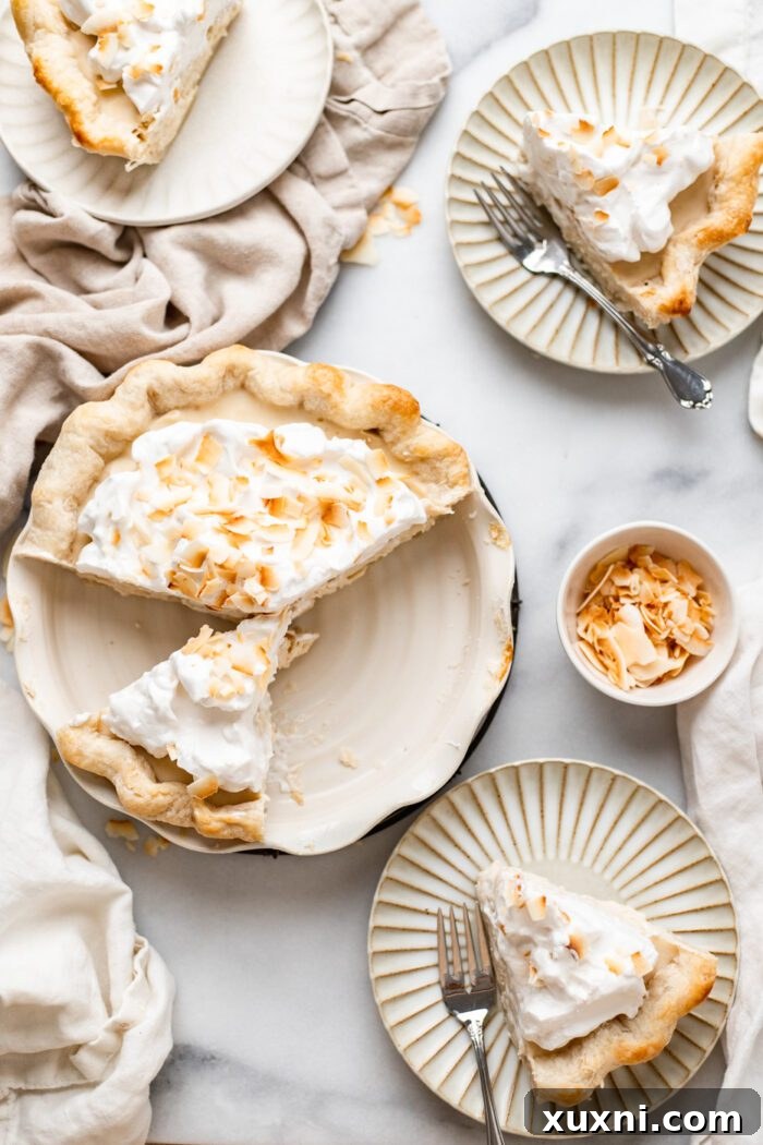 Multiple slices of vegan coconut cream pie artfully arranged on a white plate, ready for serving.