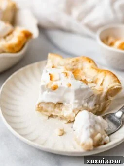 bitten slice of coconut cream pie