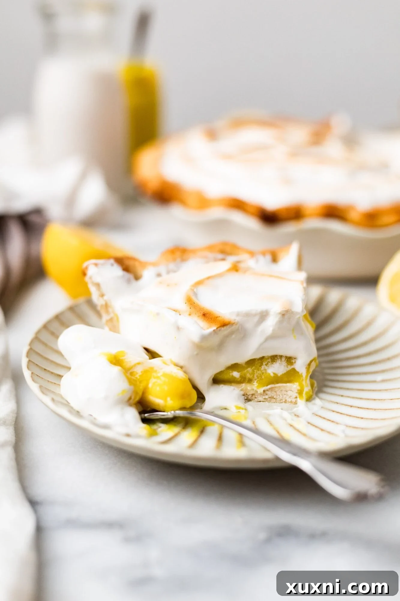 BEST Vegan Lemon Meringue Pie (Gluten Free!) - A luscious slice of vegan lemon meringue pie with a golden toasted meringue topping and a flaky crust.
