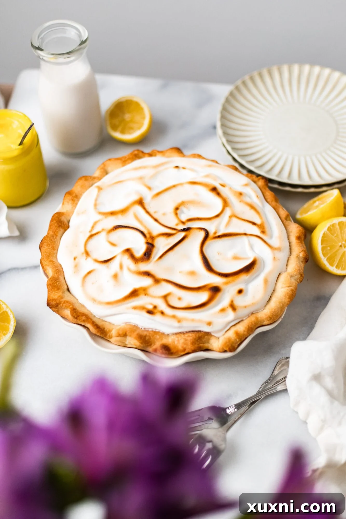 vegan lemon meringue pie - A whole vegan lemon meringue pie with perfectly toasted meringue peaks.