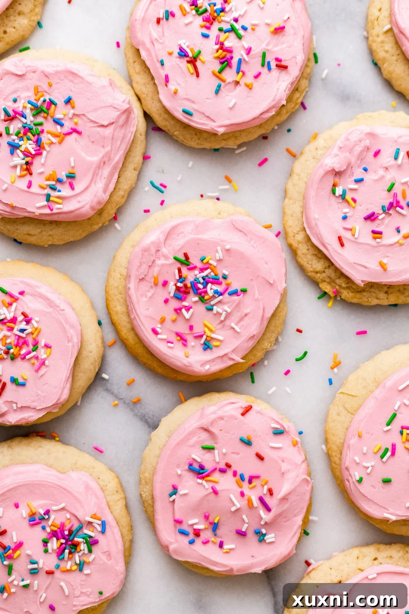 Lofthouse Cookies on marble countertop with pink frosting and sprinkles