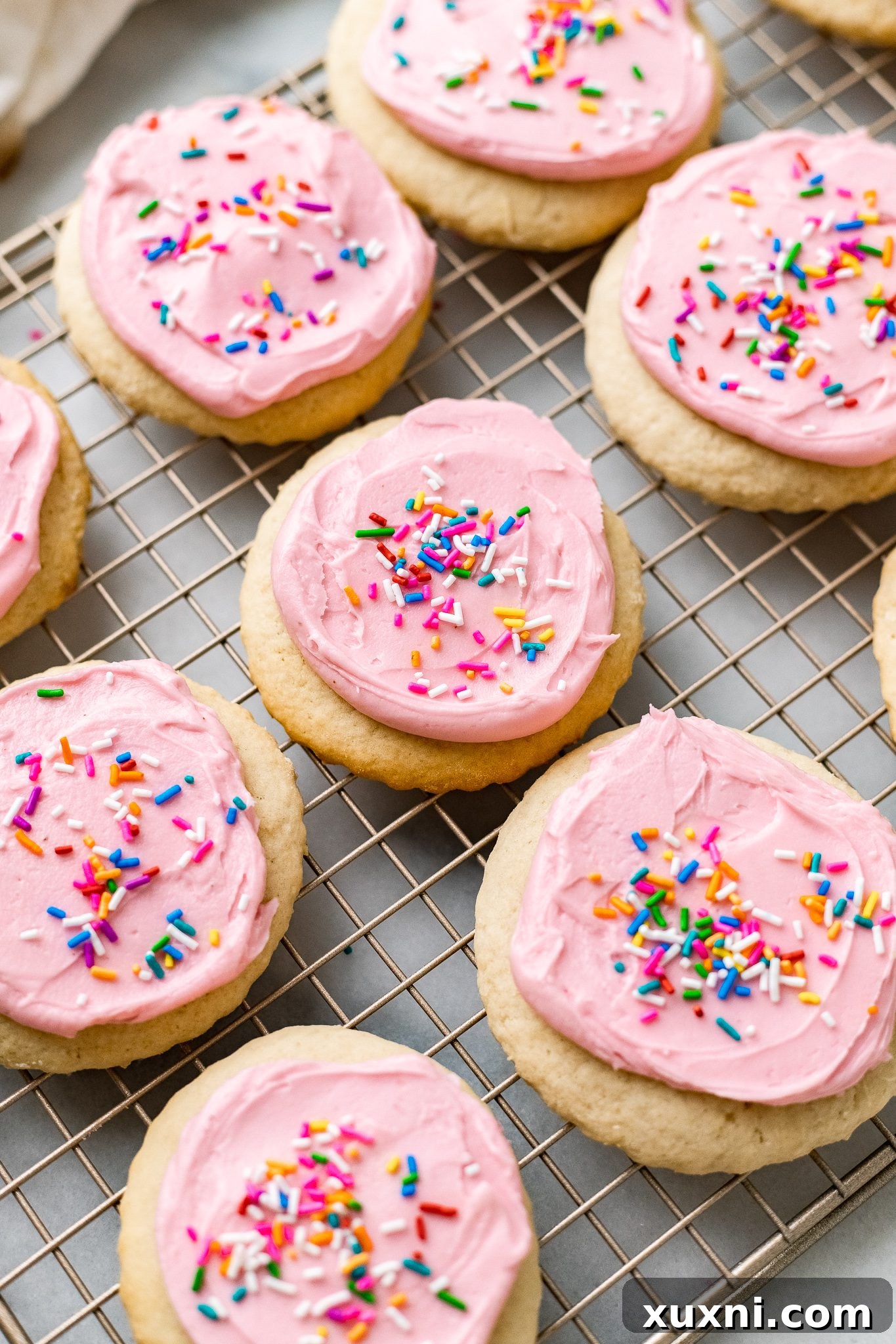 vegan Lofthouse Cookies on a cooling rack after frosting and sprinkling