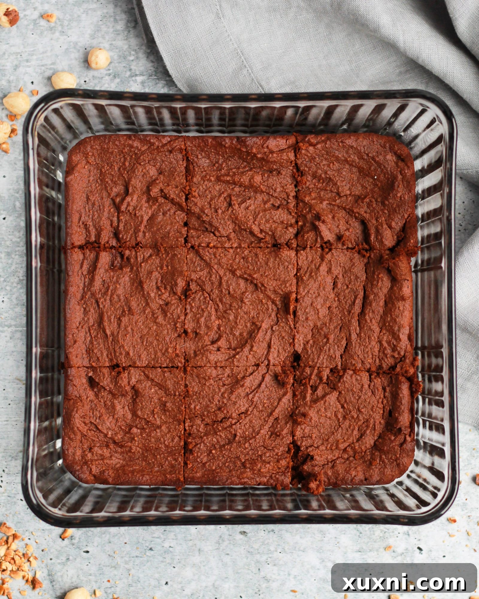 Healthy vegan Nutella brownies, perfectly baked and sliced into nine inviting squares.