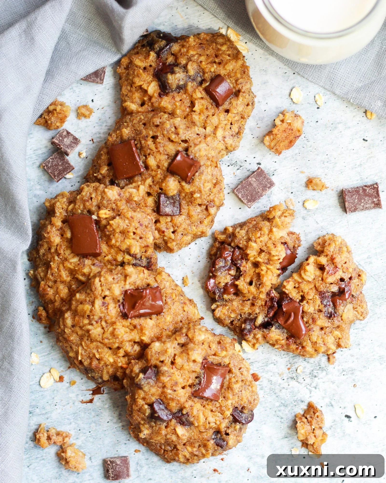 A line of healthy vegan oatmeal chocolate chip cookies, perfectly baked and ready to be enjoyed.