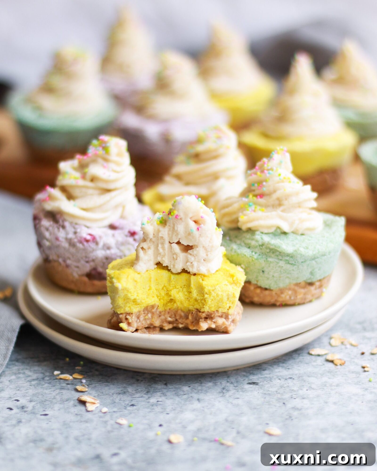 Close-up of the base of a mini vegan cheesecake, showing the oat and date crust.