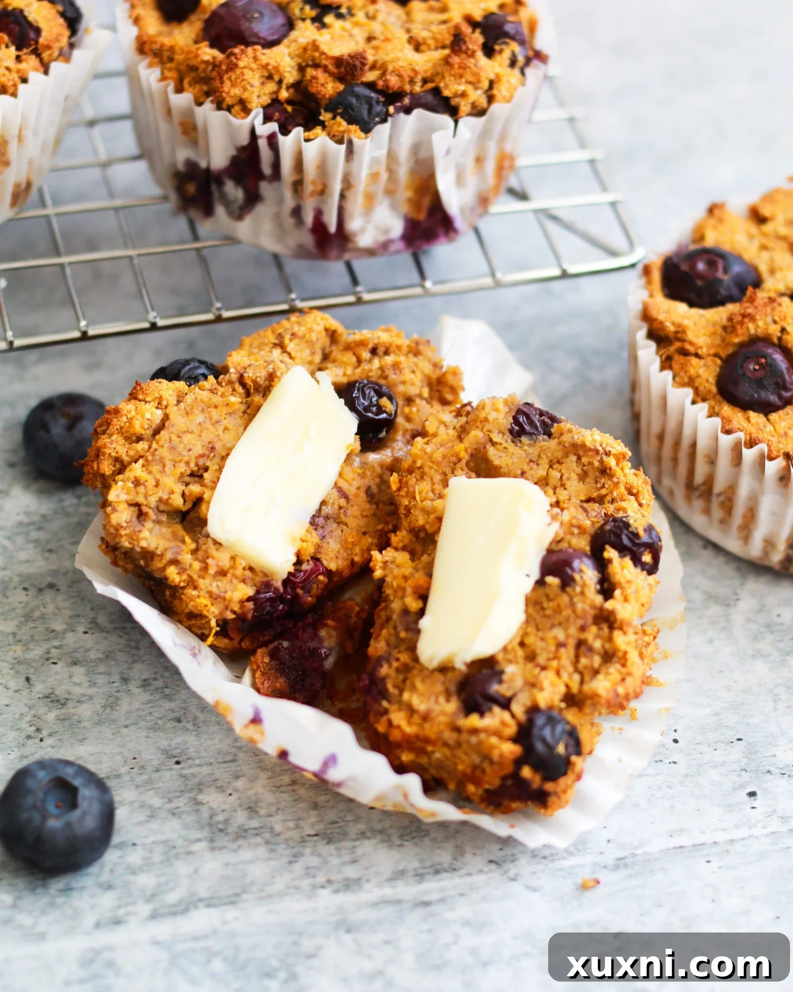 Extreme close-up of a single vegan blueberry muffin, focusing on its intricate texture and juicy blueberries.