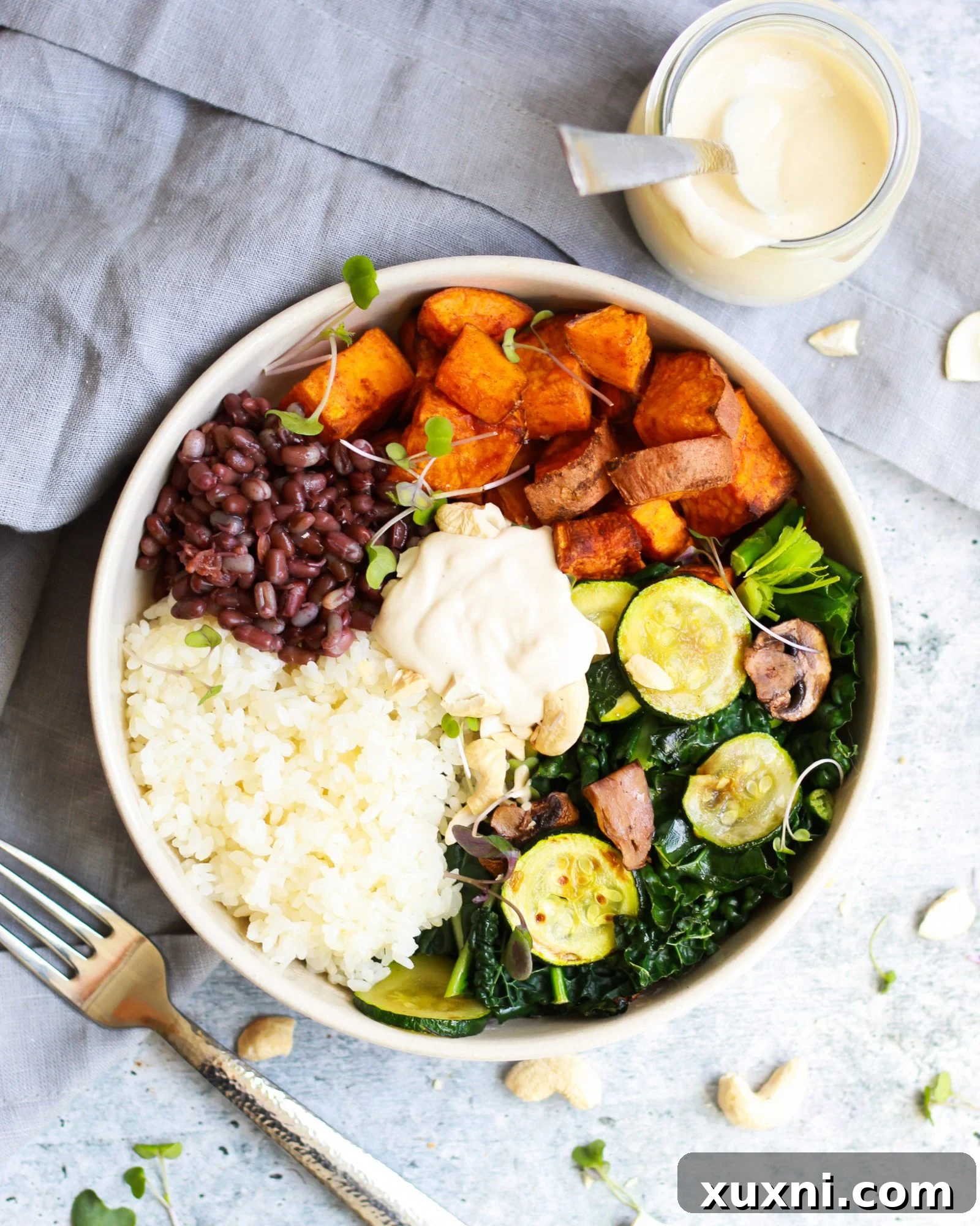 overhead shot of macrobiotic bowl drizzled in the best tahini sauce