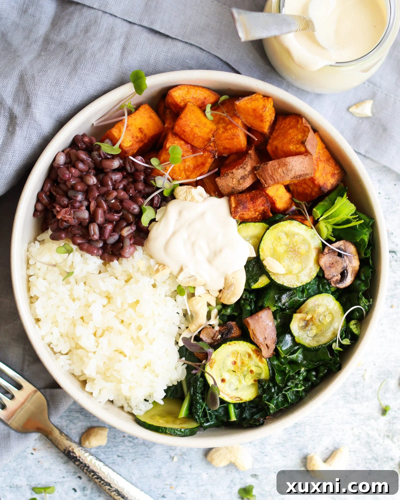 overhead shot of macrobiotic bowl drizzled in the best tahini sauce