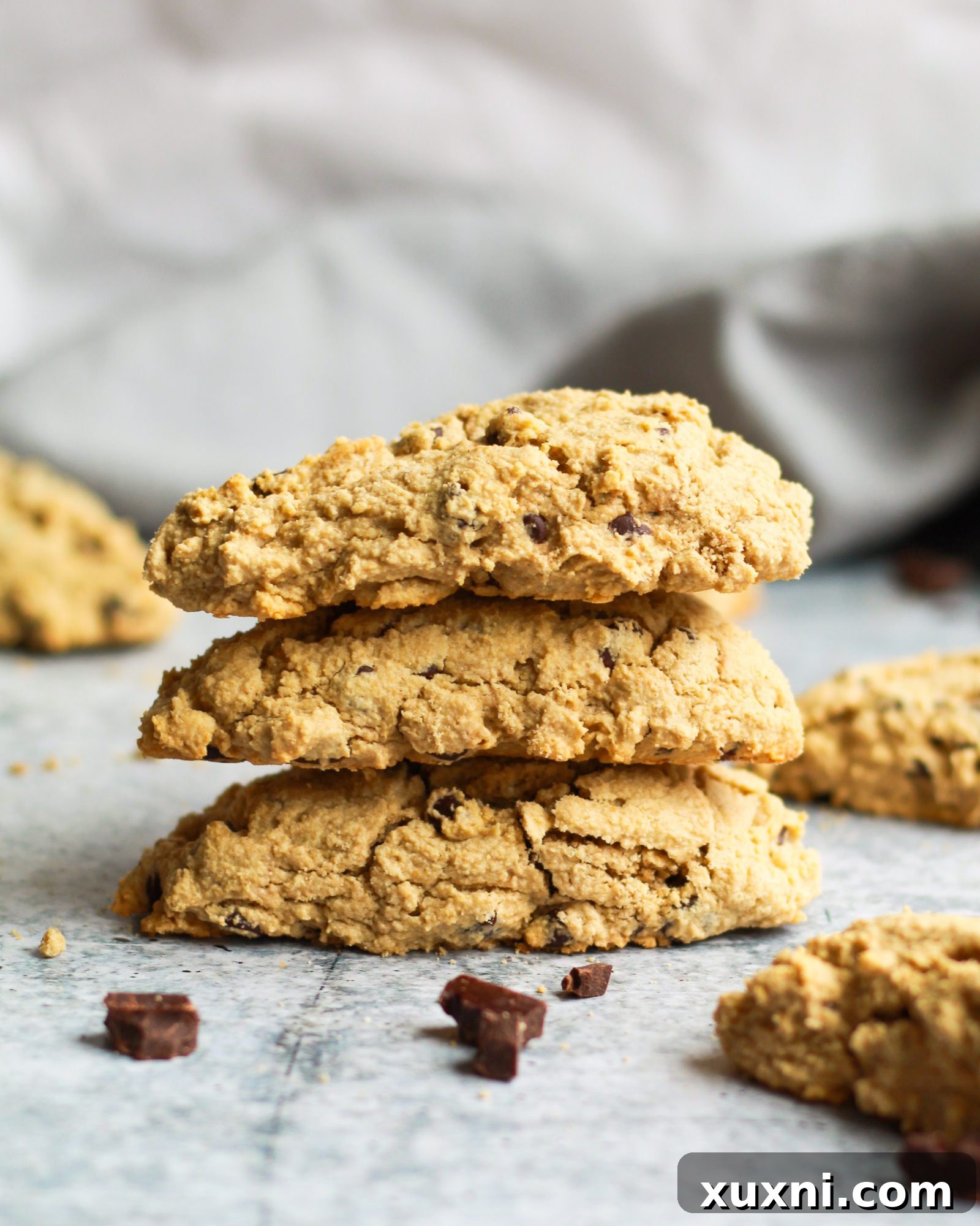 Stack of three healthy chocolate chip scones, showing their golden tops and generous chocolate chip distribution