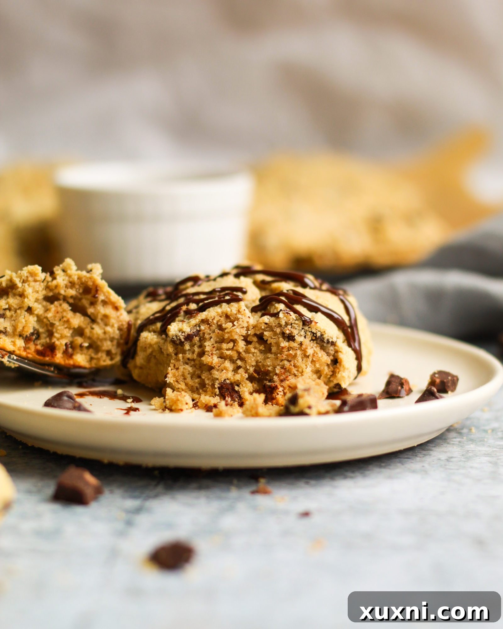 Healthy chocolate chip scone with a bite taken out, revealing its soft interior and melted chocolate