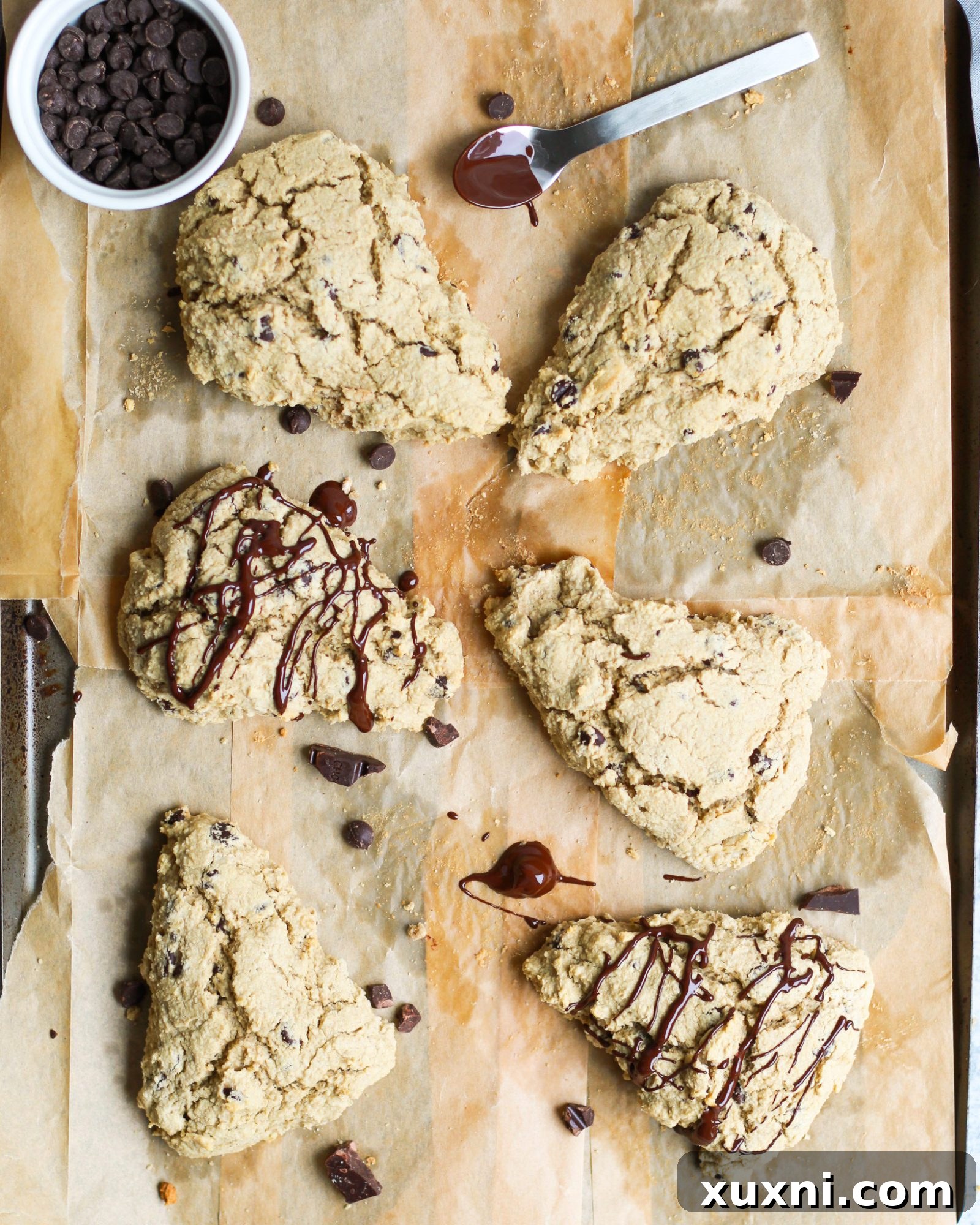 Baking sheet filled with raw chocolate chip scone triangles ready for baking