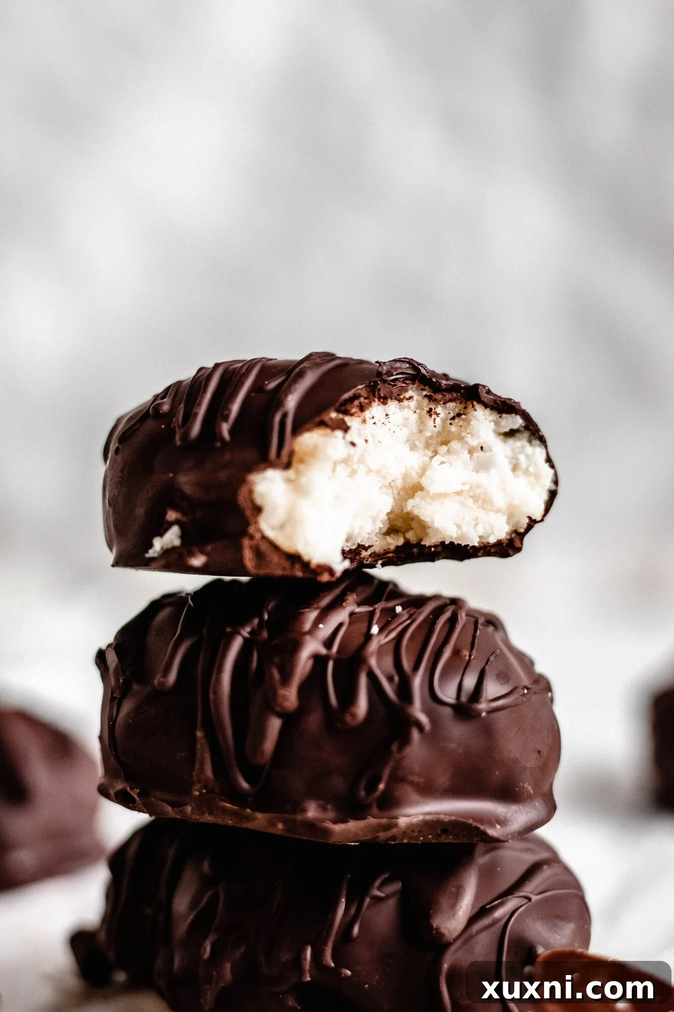 An artfully arranged close-up of several homemade coconut cream eggs, showcasing their smooth chocolate coating and festive appeal.