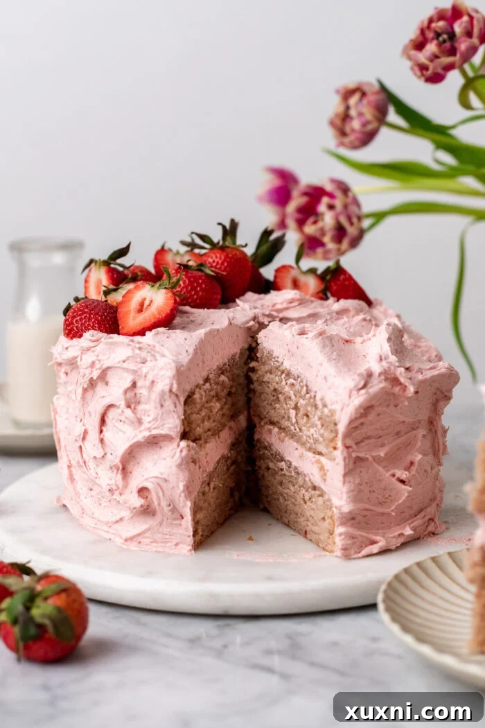 Delightful slice of homemade vegan strawberry cake, revealing its beautiful layers and tender crumb.