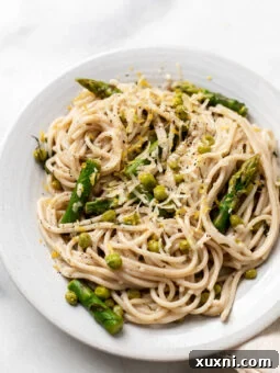 plate of vegan lemon pasta with asparagus and peas