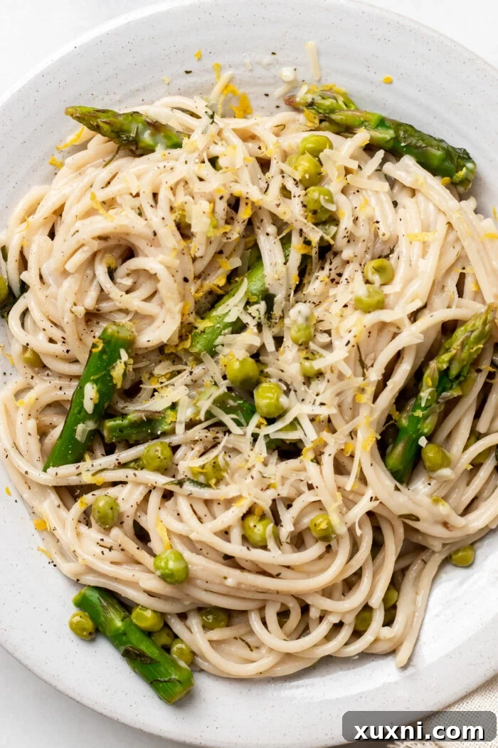 close up of creamy lemon asparagus and pea pasta on a plate