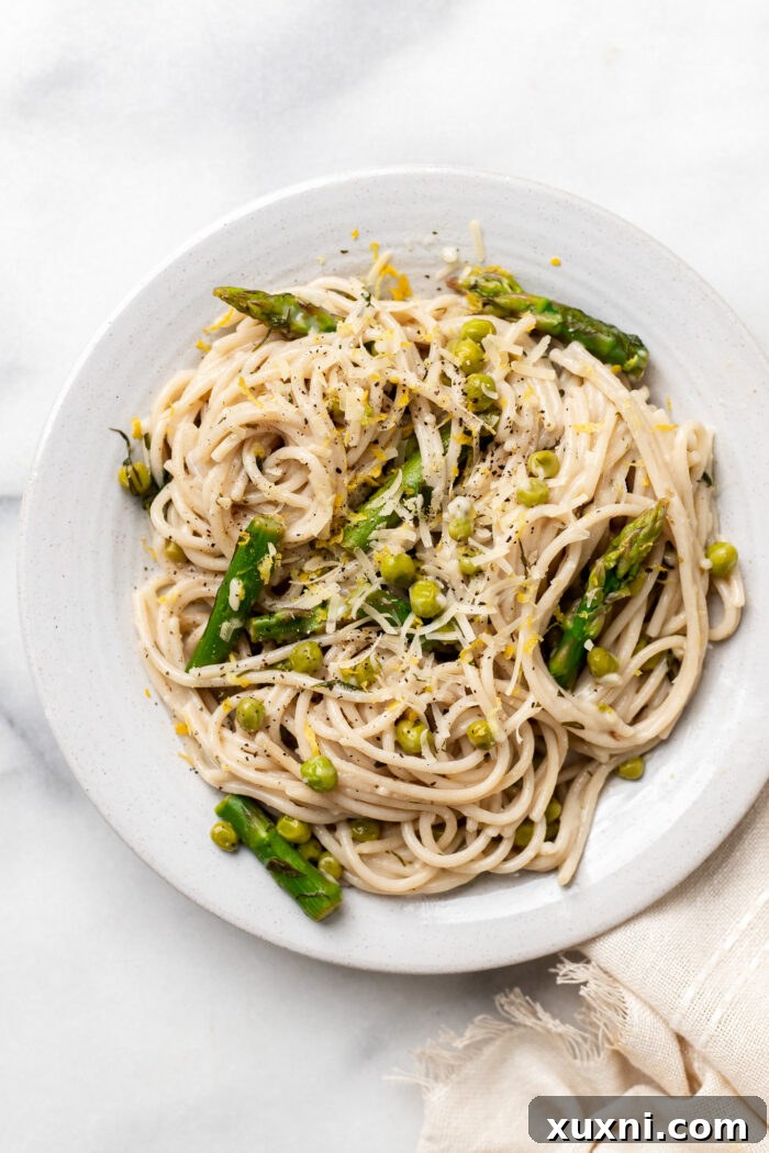 plated vegan lemon pasta with asparagus and peas