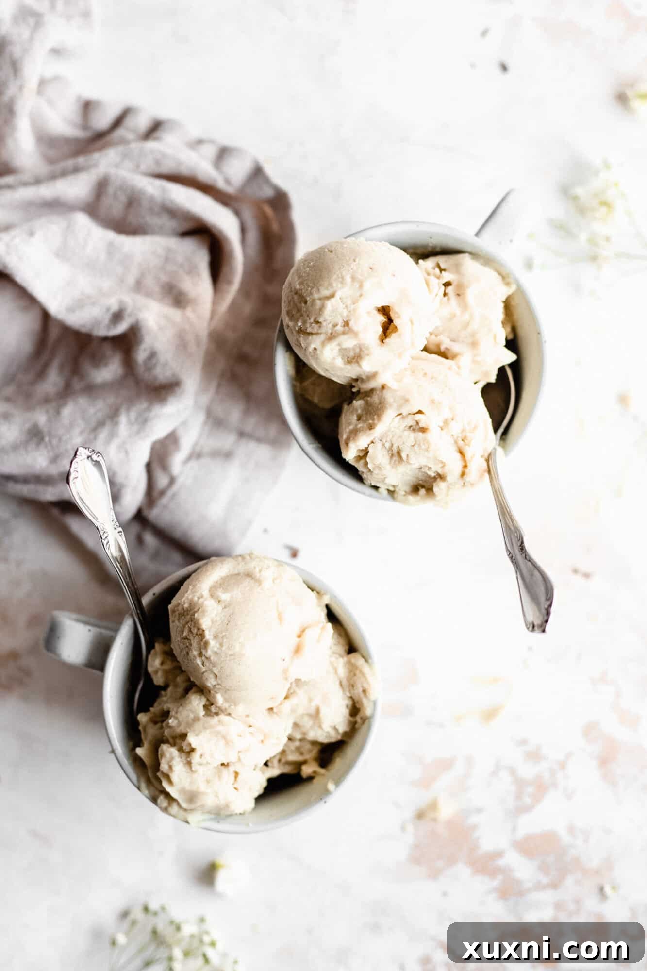 More mugs of vegan vanilla ice cream, artfully arranged