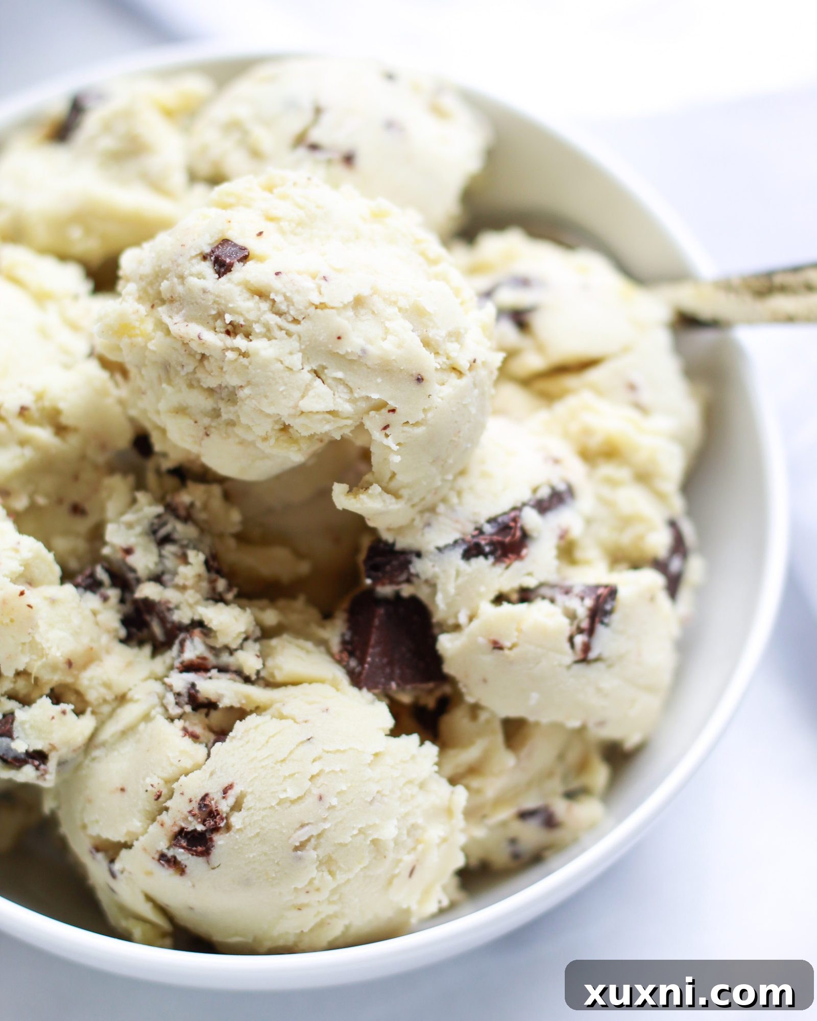 Close up of a single scoop of vanilla ice cream showing its texture