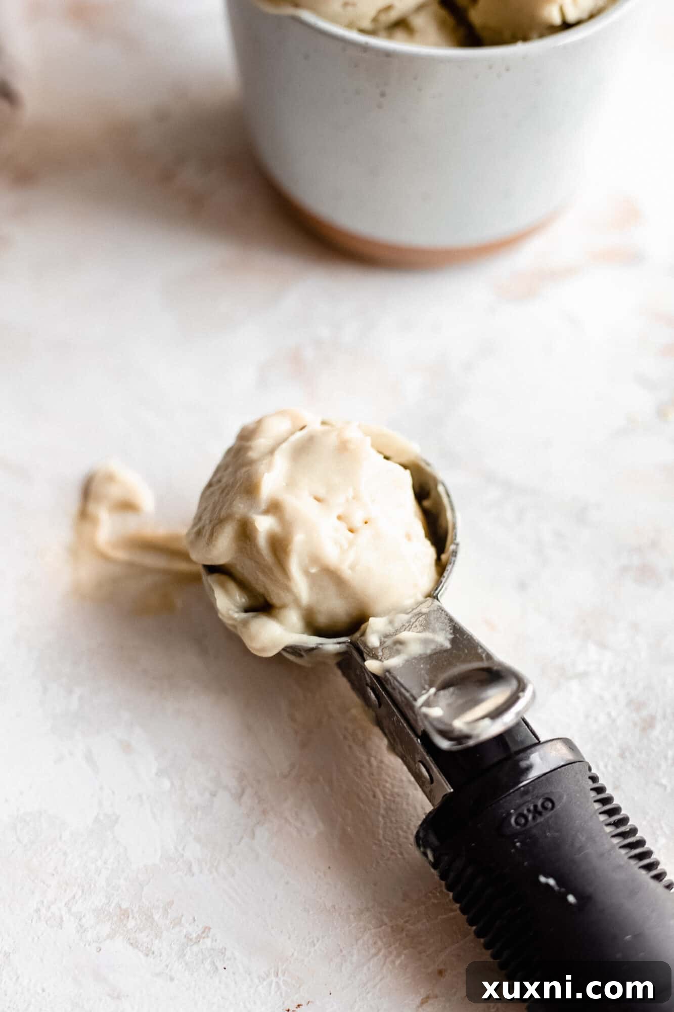 Scoop of vegan vanilla ice cream demonstrating its creamy texture