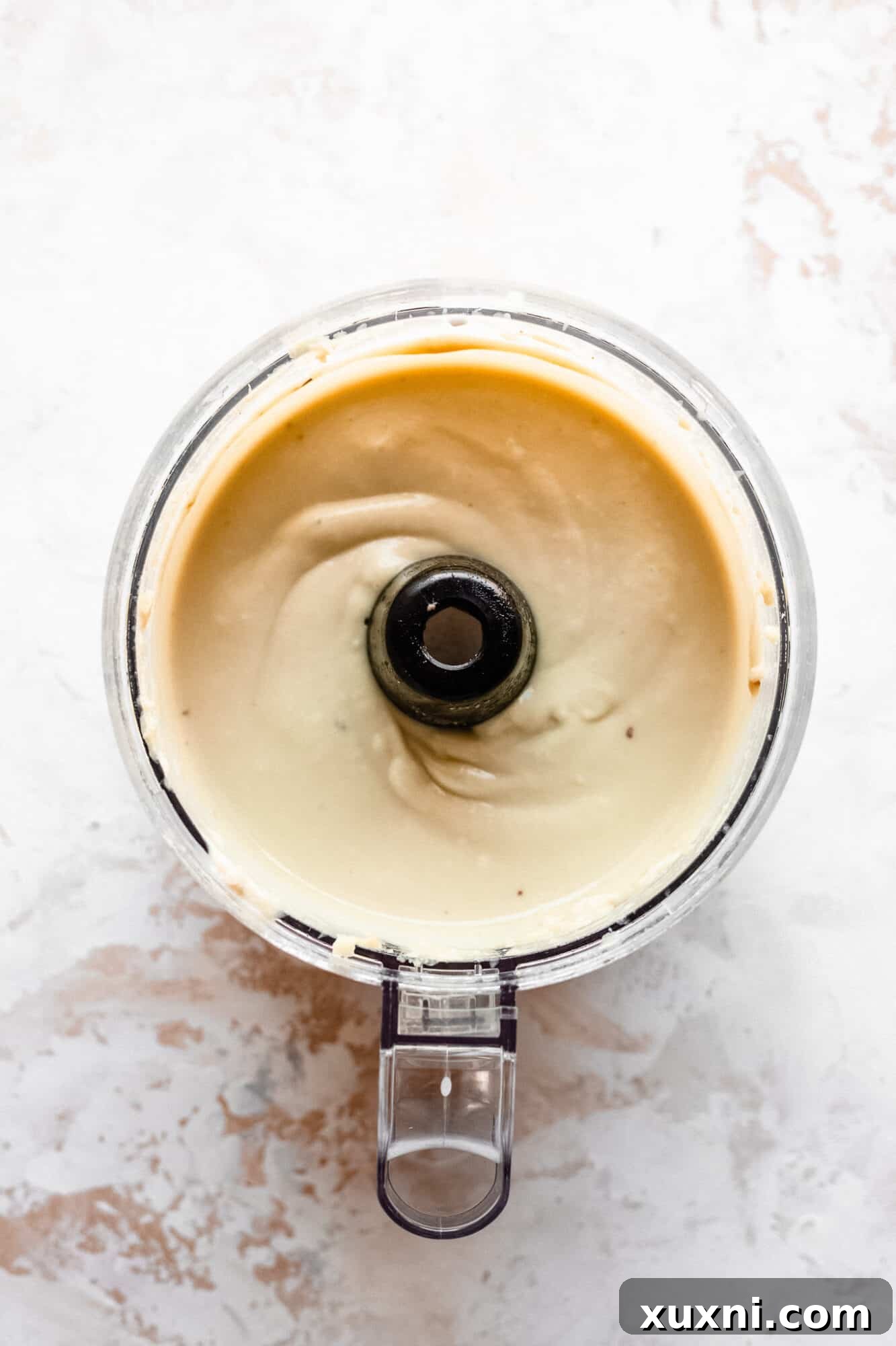 Paleo vegan vanilla ice cream mixture in a food processor, blending smooth