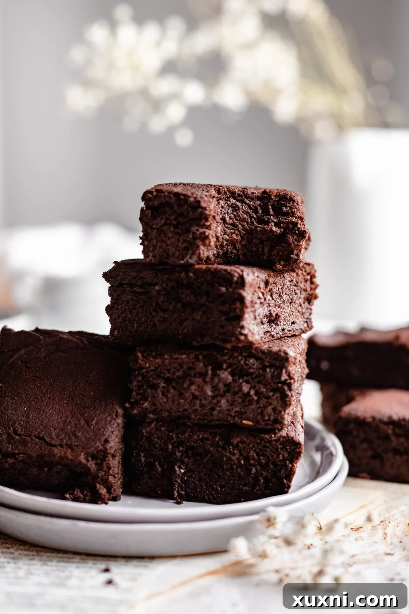 stacked vegan sweet potato brownies, featuring a rich, dark chocolate color and smooth texture