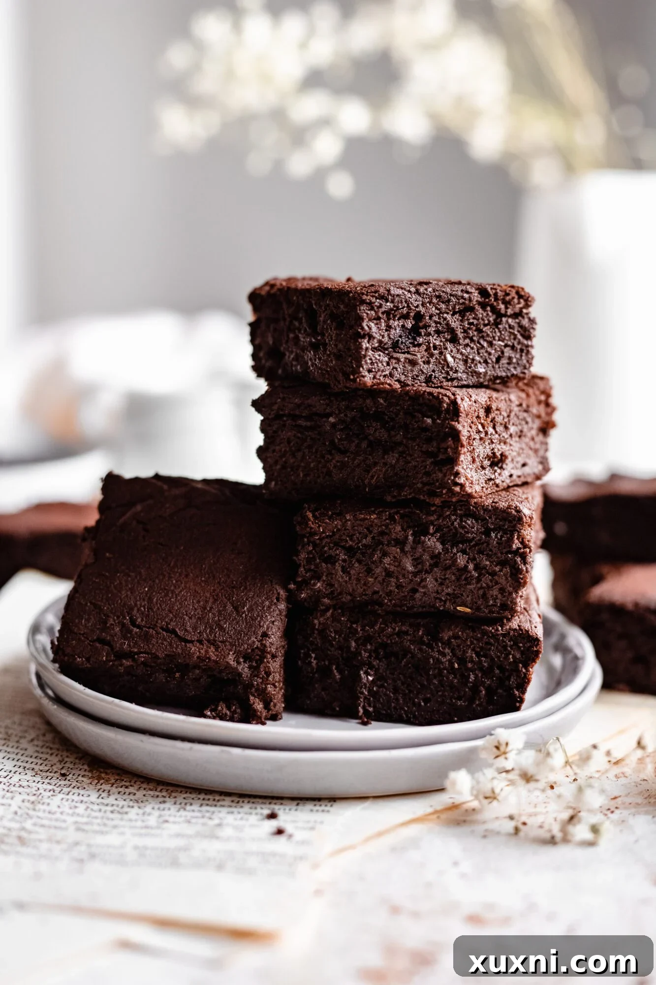 paleo vegan sweet potato brownies, perfectly stacked on parchment paper