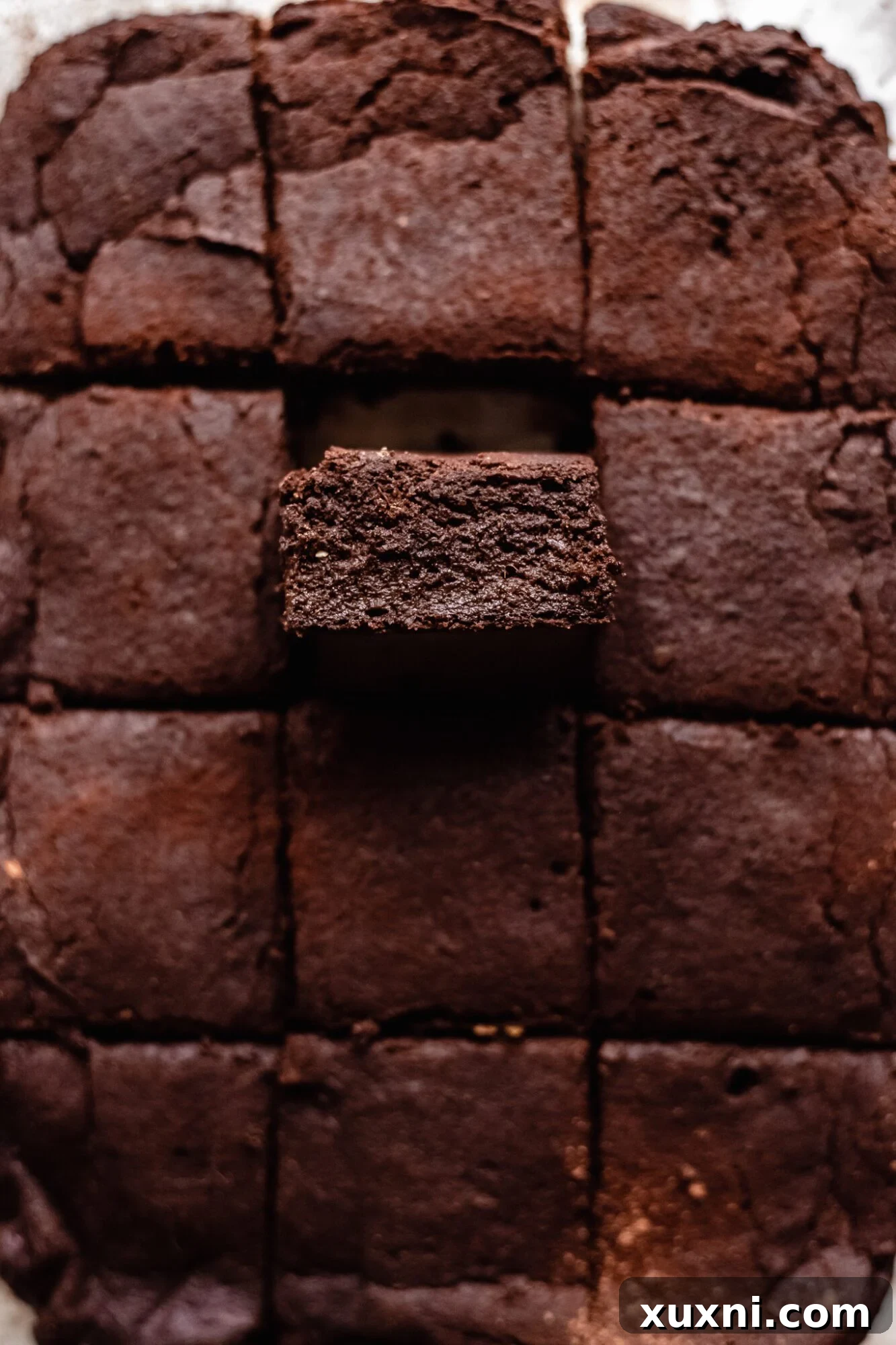 close-up of a single sweet potato brownie, showcasing its dense, fudgy interior