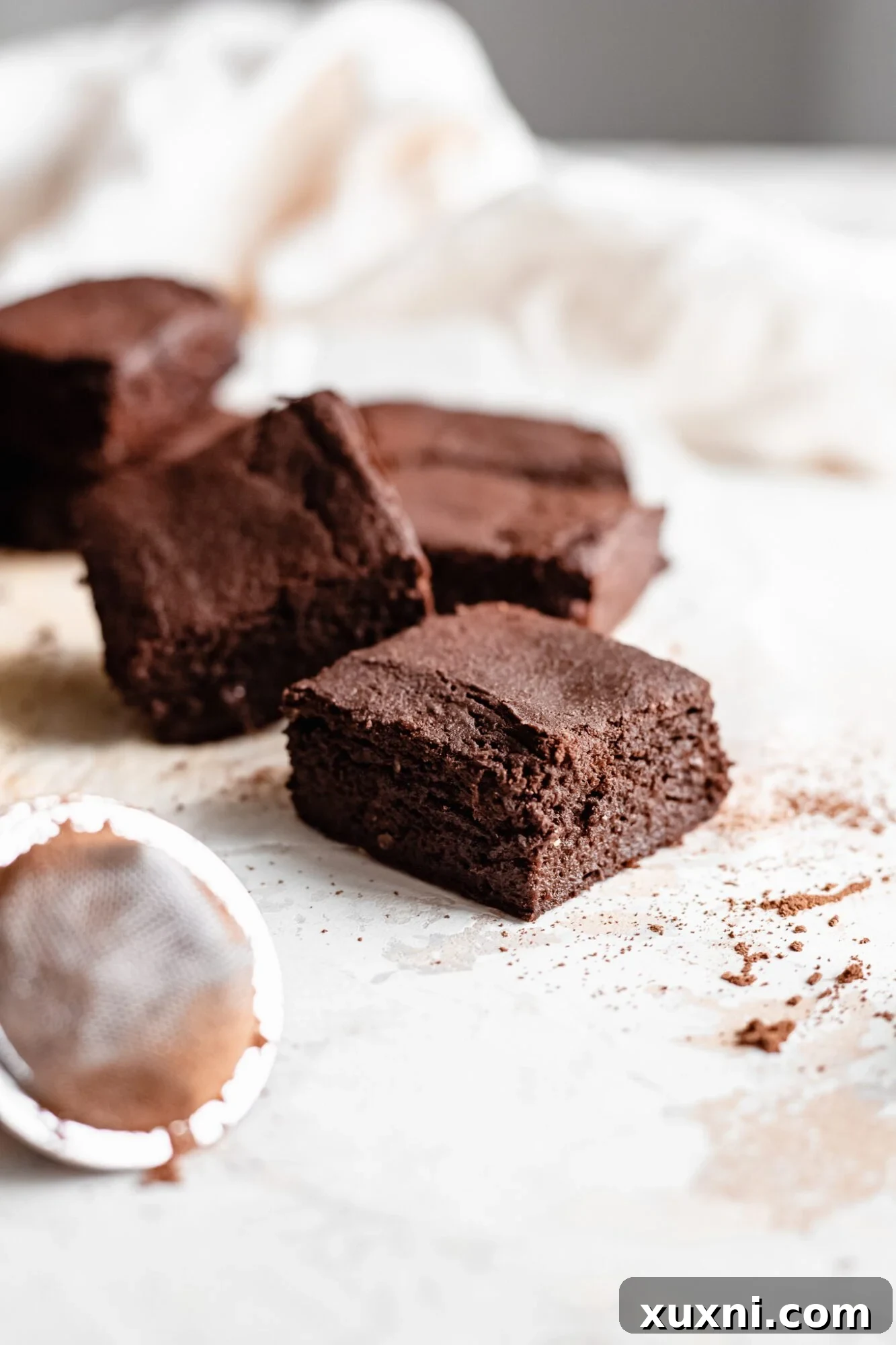 a single sweet potato brownie sits elegantly on parchment paper