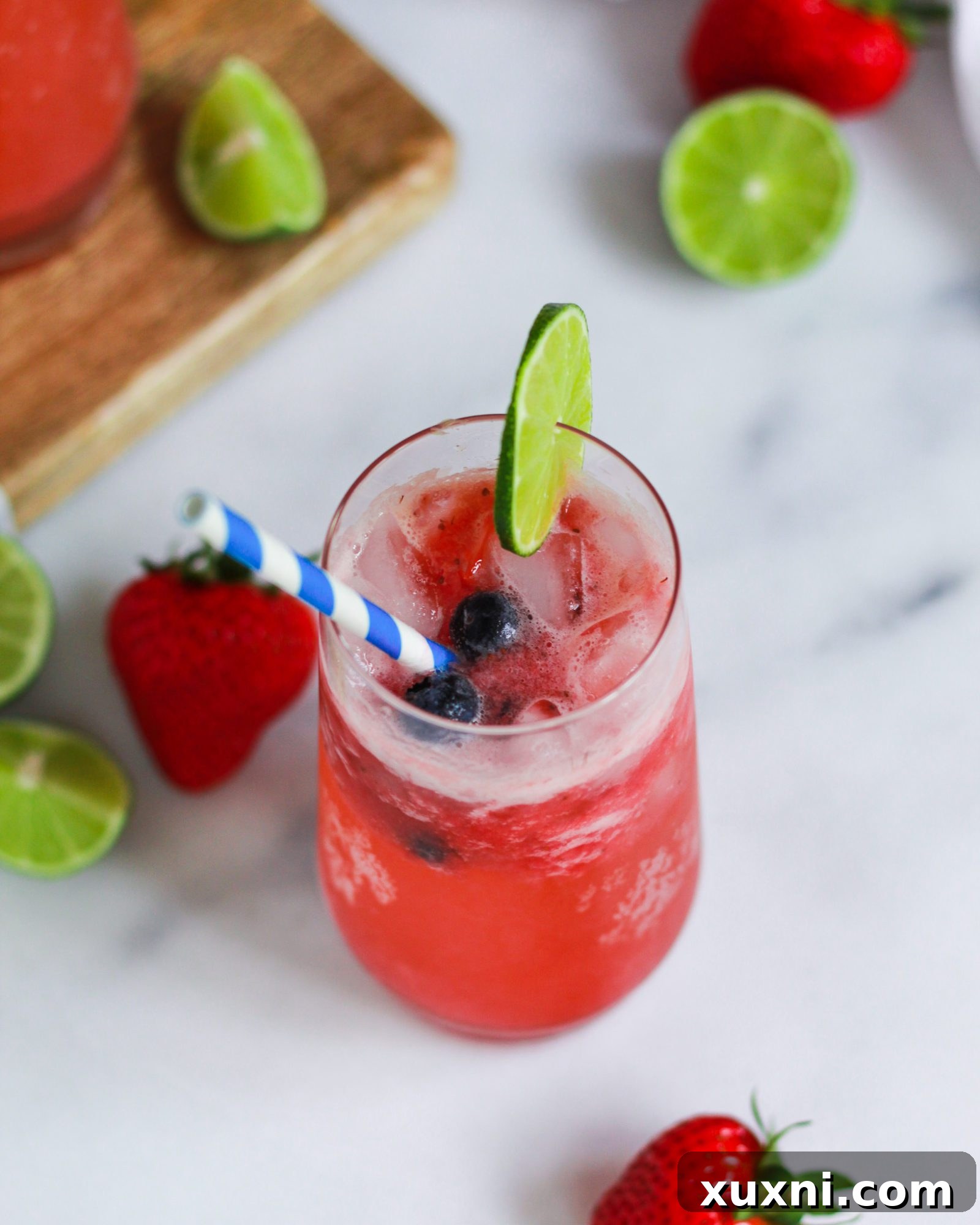 Blushing Berry Mockarita 3 Close-up shot of a single virgin strawberry margarita, showcasing its vibrant red color and icy texture.
