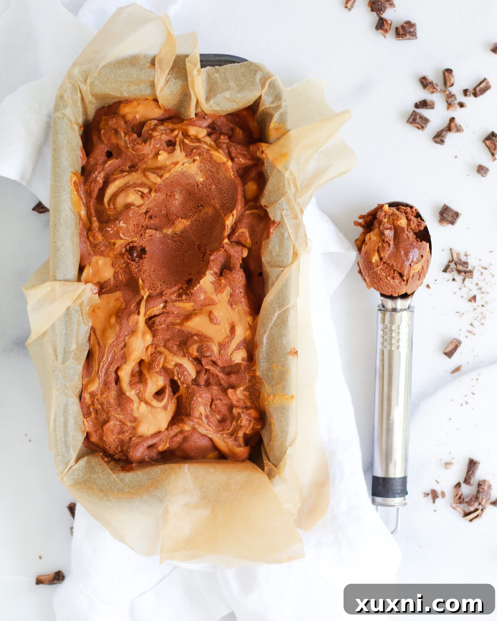 scoop of ice cream next to ice cream container