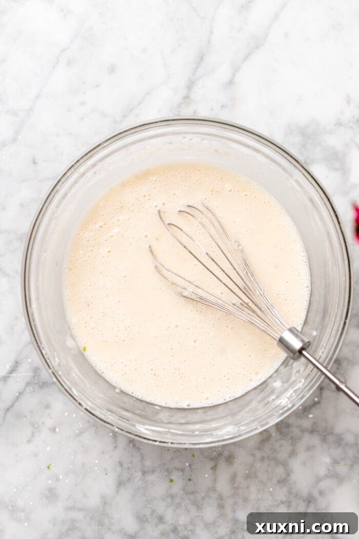 key lime pie filling being whisked in a bowl