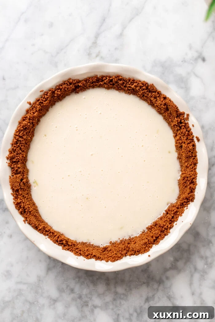 key lime pie filling poured into the crust before baking