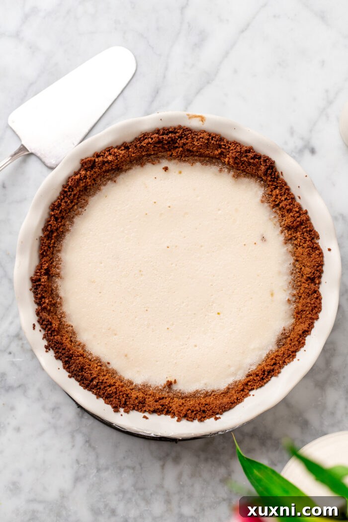 key lime pie removed from oven, cooling on a wire rack