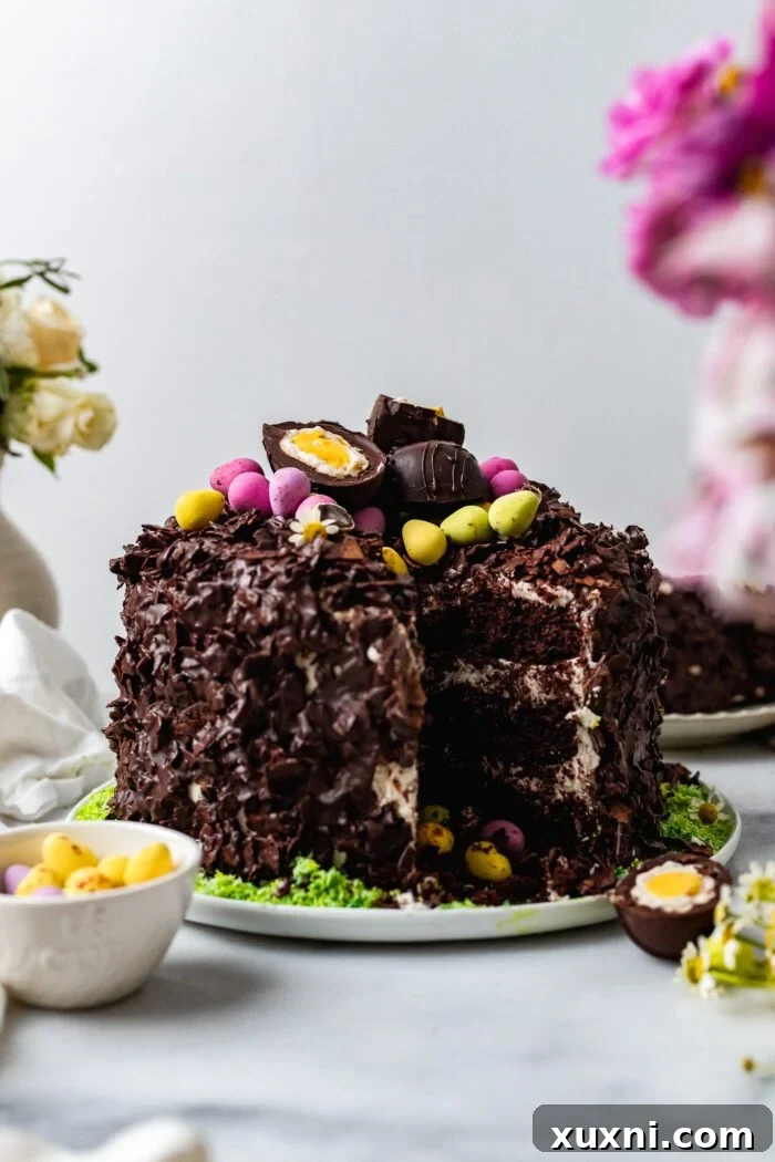 Decadent vegan chocolate coconut Easter egg nest cake, beautifully decorated on a plate.