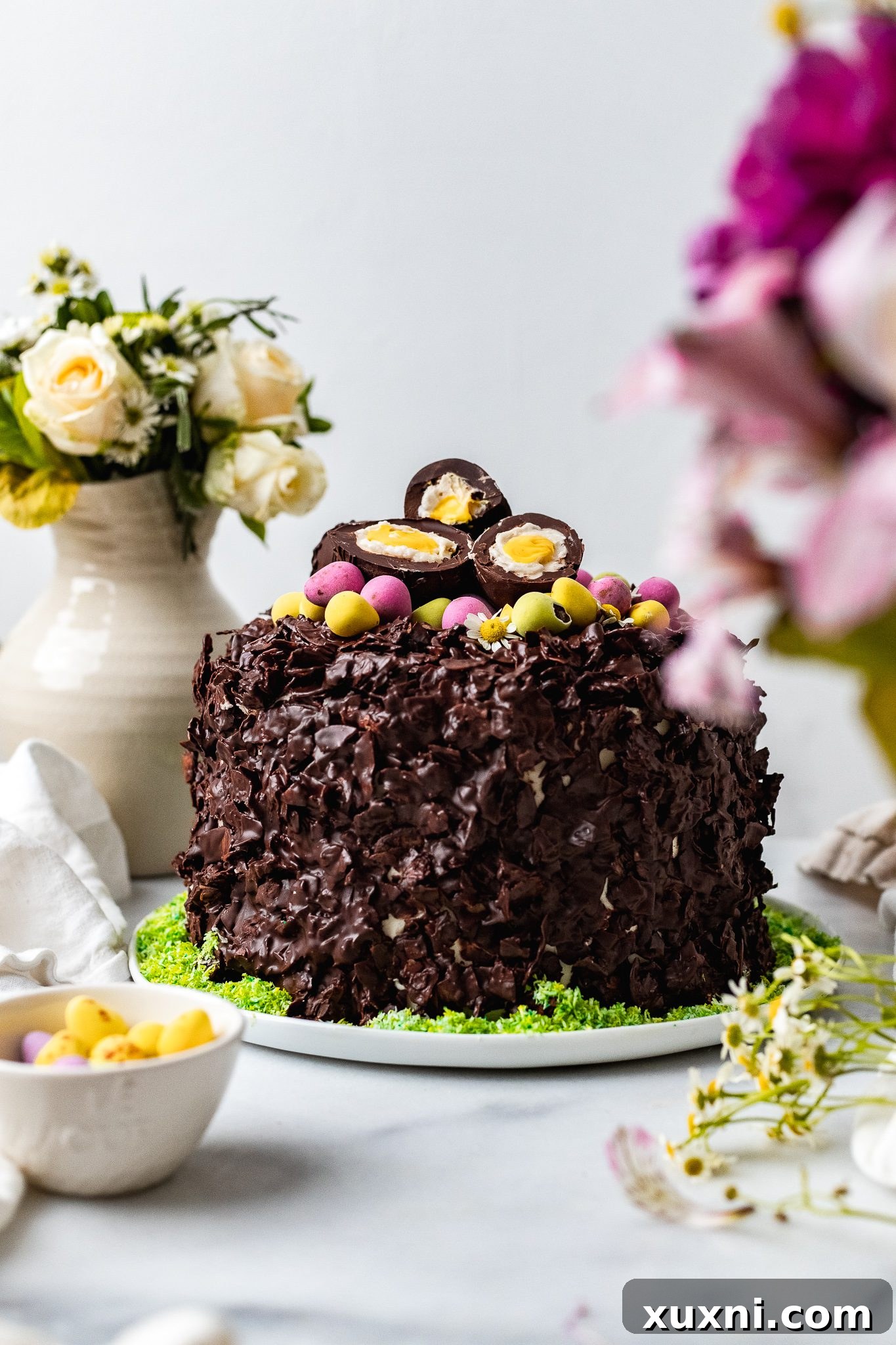 Fully assembled vegan chocolate coconut Easter cake, ready for the final touches.