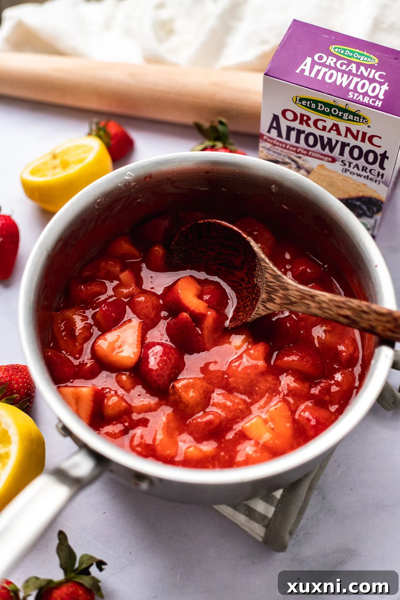 Cooked strawberry pie filling in a saucepan, showcasing its rich, jammy consistency after thickening.
