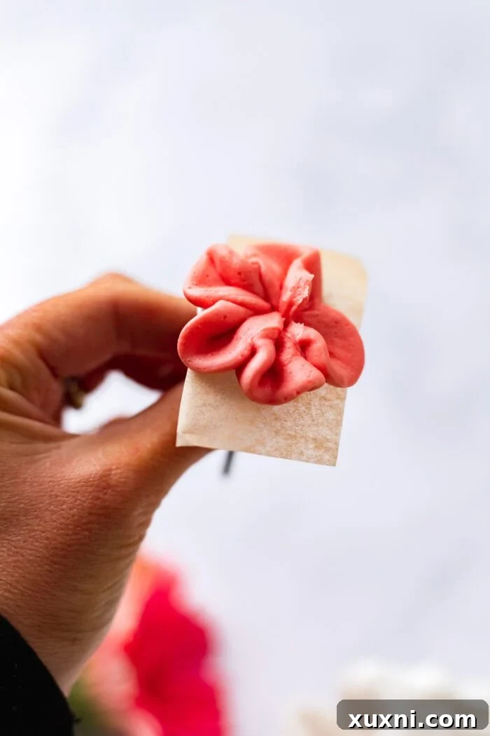 Easy Buttercream Blooms Cake 5 Close-up of a piped buttercream rose on a flower nail, ready to be chilled and transferred to the cake
