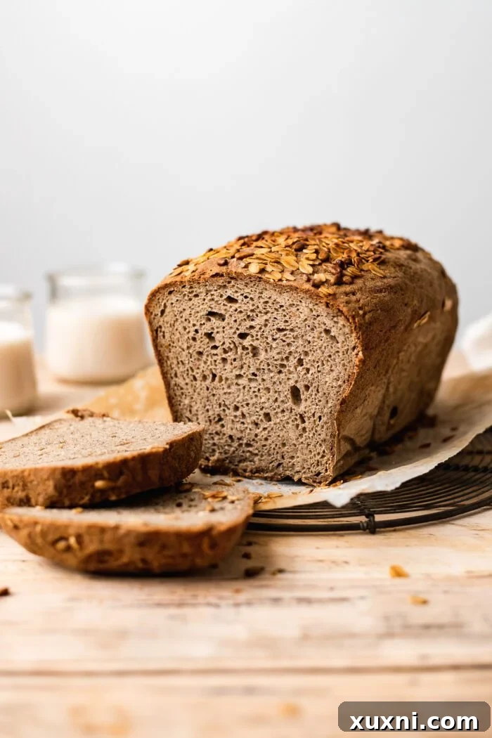 Your Perfect Gluten-Free Sandwich Bread: Homemade, Egg & Dairy-Free 2 Freshly baked gluten-free bread loaf, perfectly sliced, showcasing its soft, open crumb texture.