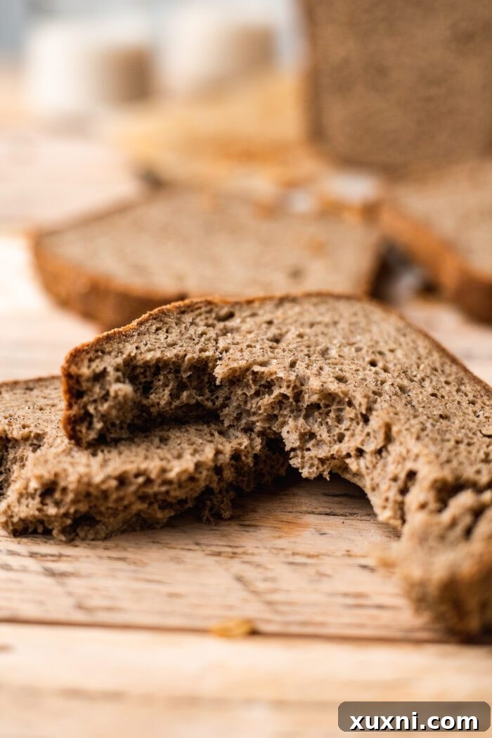 Your Perfect Gluten-Free Sandwich Bread: Homemade, Egg & Dairy-Free 11 A freshly baked gluten-free sandwich bread loaf, artfully torn in half to reveal its soft, airy, and beautifully textured interior.