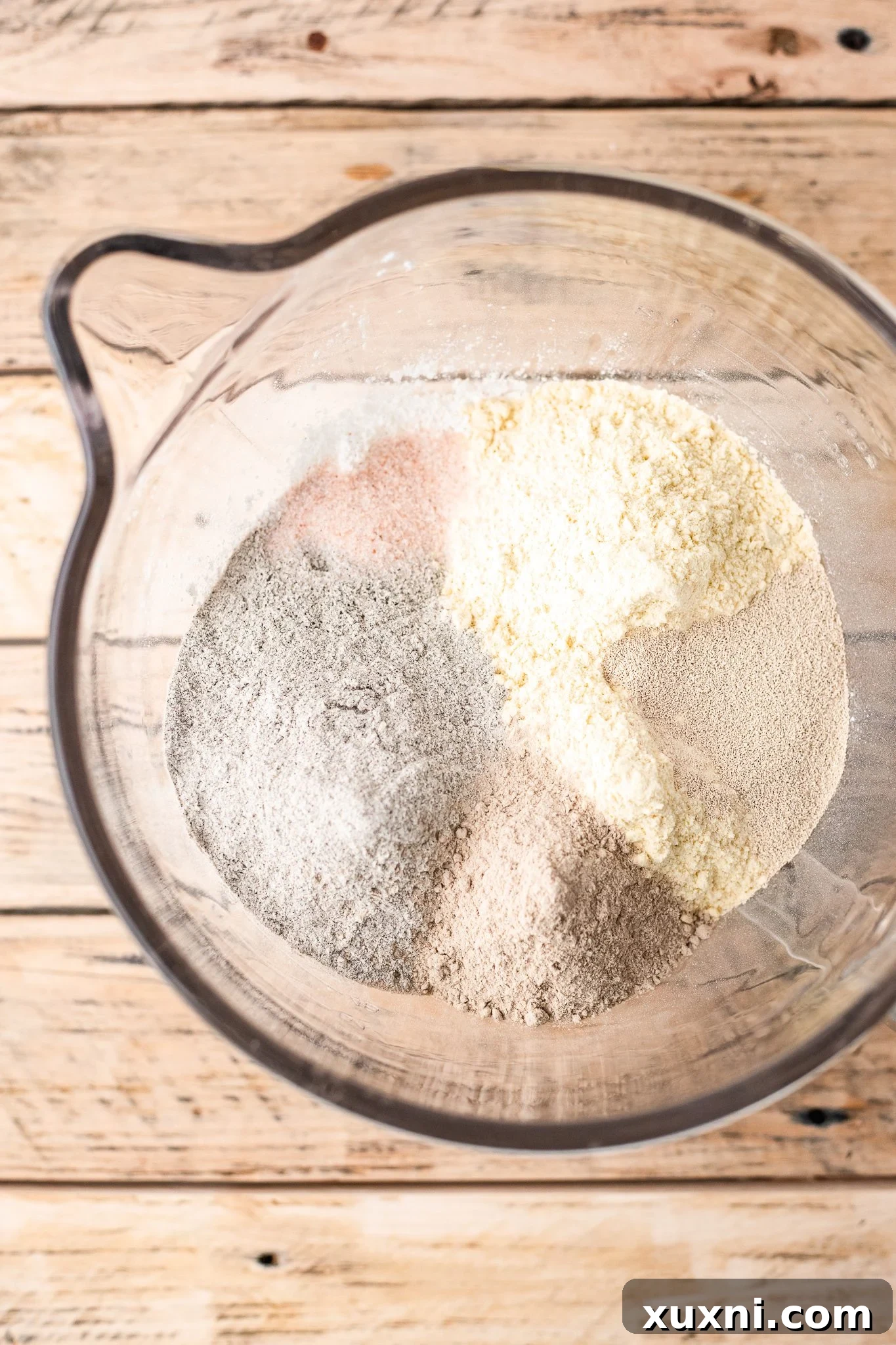 Your Perfect Gluten-Free Sandwich Bread: Homemade, Egg & Dairy-Free 5 Dry ingredients for gluten-free vegan bread, including flours, salt, and yeast, perfectly measured in a mixing bowl.
