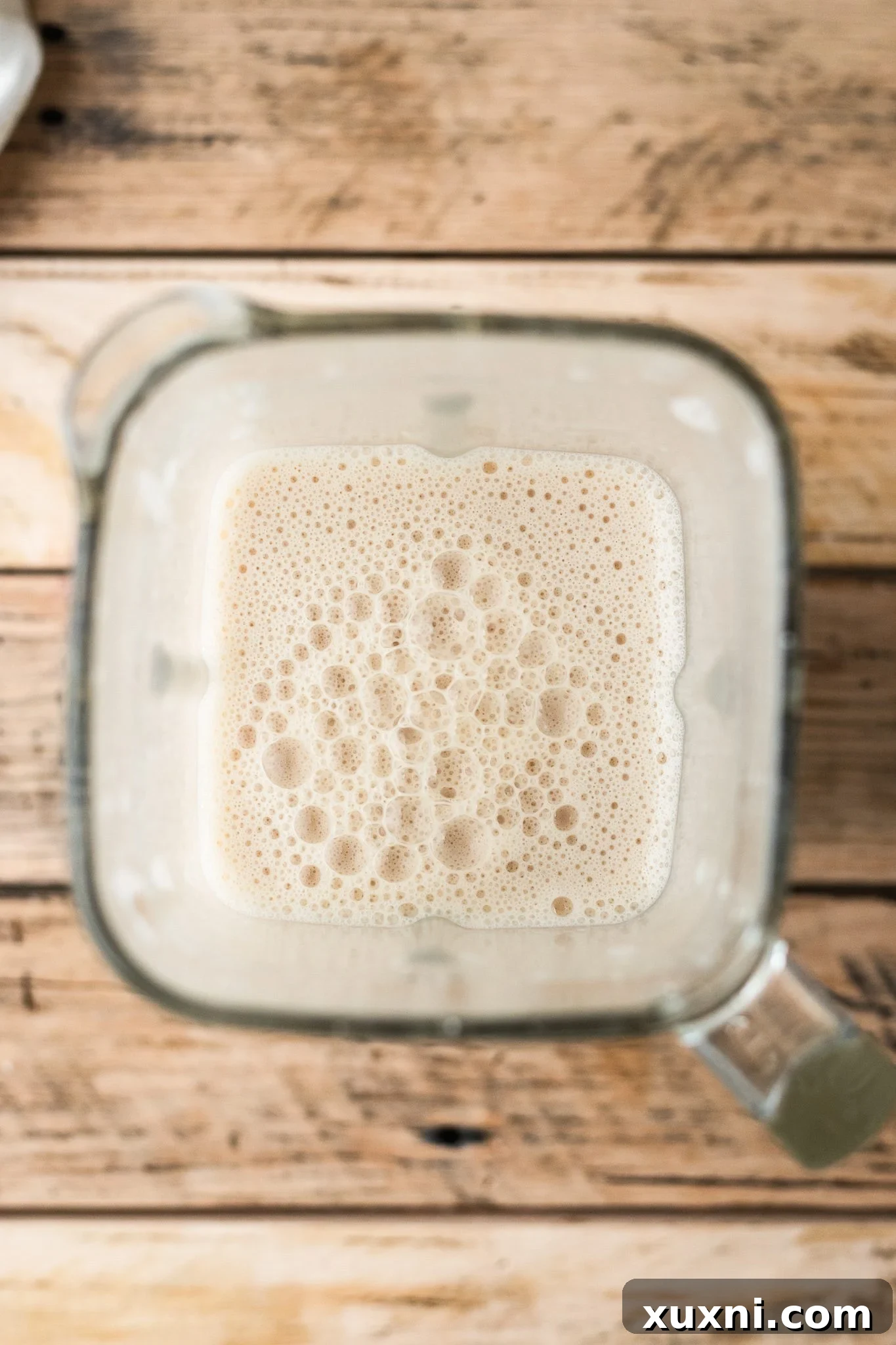 Blended creamy dairy-free mozzarella ingredients in a high-speed blender