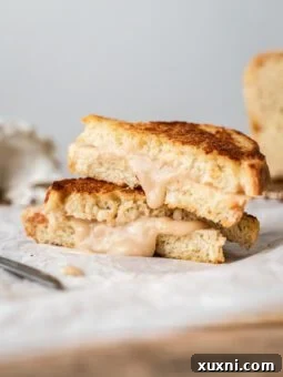Gooey vegan grilled cheese with bean-based mozzarella on parchment paper