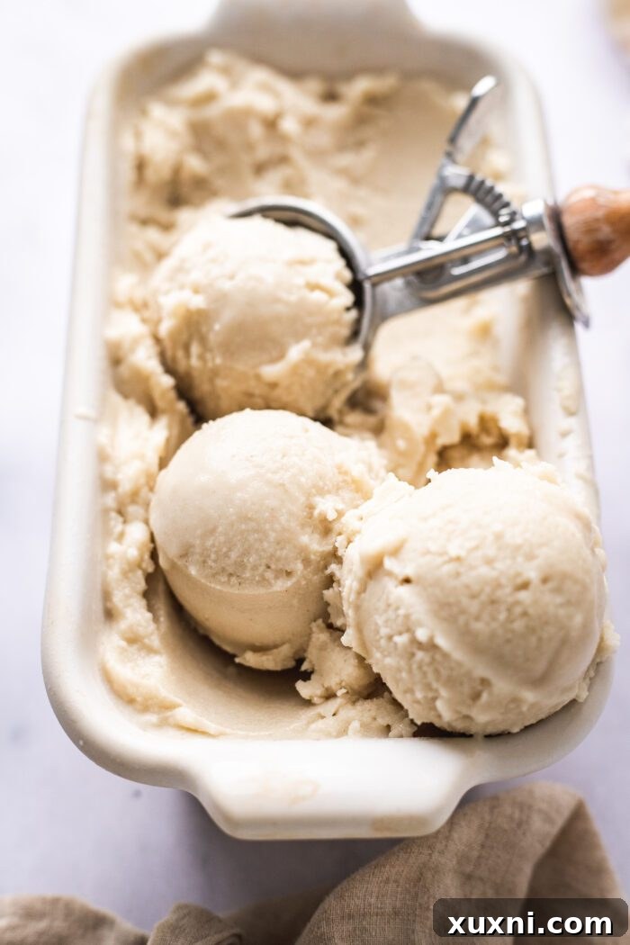 Scoops of creamy vegan vanilla ice cream in a bowl