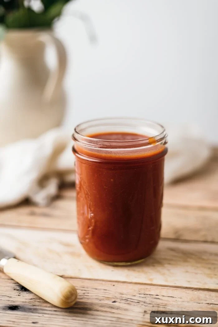 jar of vegan bbq sauce, rich and glossy