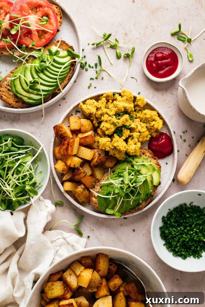 fluffy vegan chickpea scramble on a plate garnished with herbs
